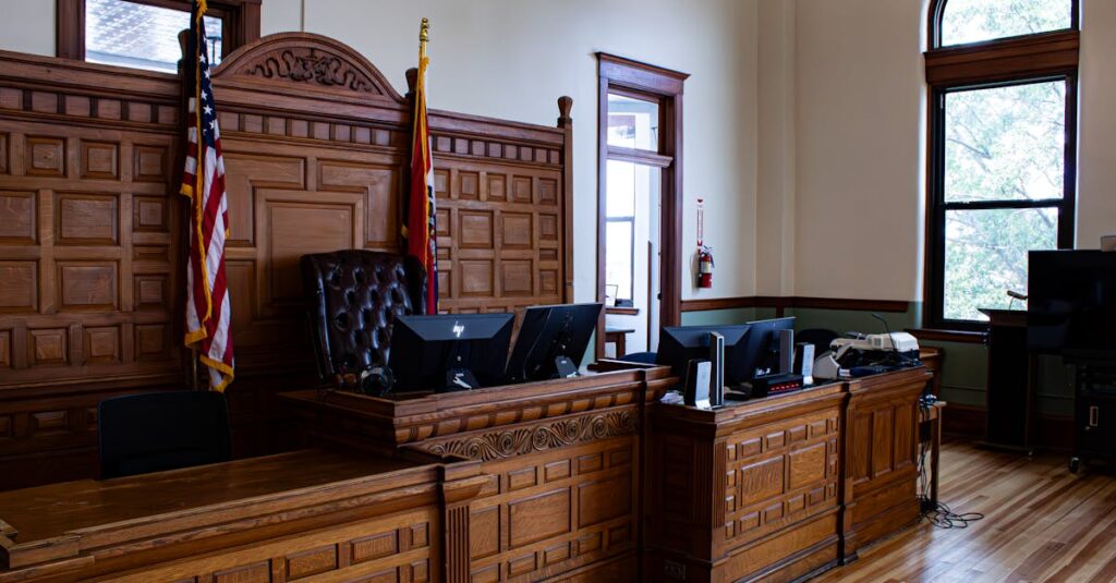 Interior view of an American courthouse in Kirksville, Missouri, featuring a judge's desk and flags.