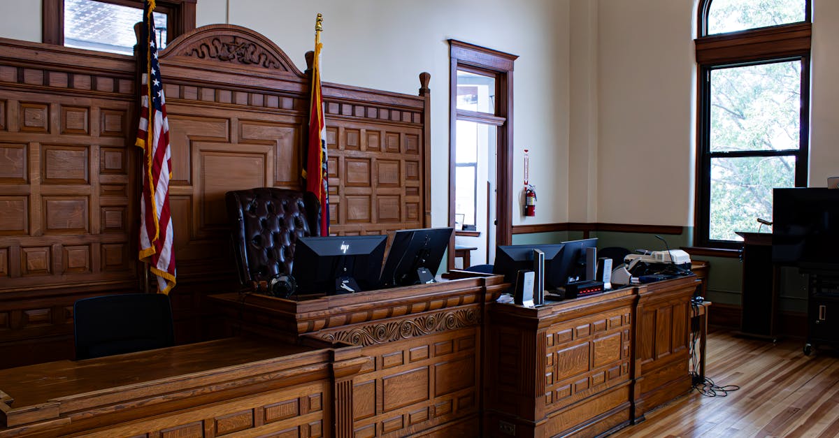 Interior view of an American courthouse in Kirksville, Missouri, featuring a judge's desk and flags.