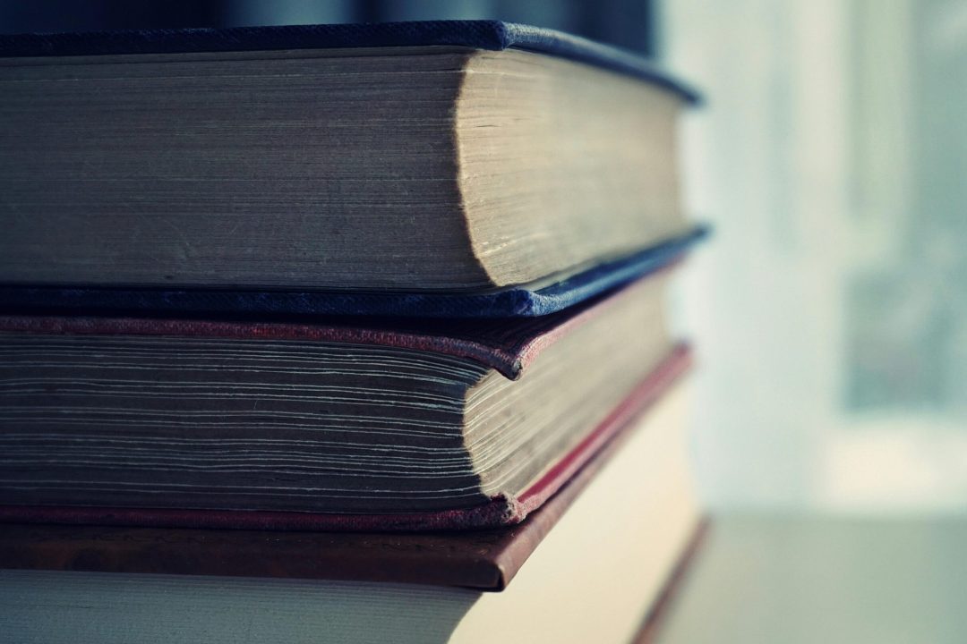 Close-up shot of stacked vintage books with soft focus on pages, perfect for educational themes.